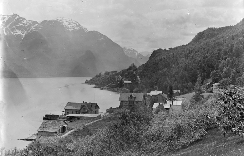 Døsen i Luster. Tingstova ligg til venstre, nesten i sjøkanten, og hovudbygningen til høgre. Biletet er teke ovanifrå og ut fjorden. Sørheimsfjell i bakgrunnen.